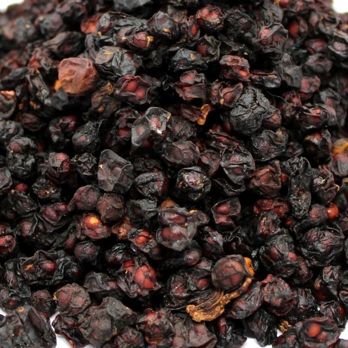 A close up shot of a pile of organic schisandra berries.