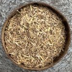 Organic dried Ashwagandha root pieces in a wooden bowl