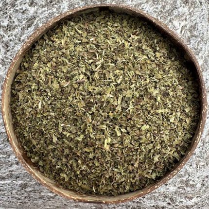 Organic dried peppermint leaves in a coconut bowl