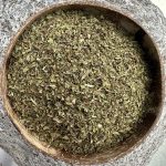 Organic dried peppermint leaves in a bowl